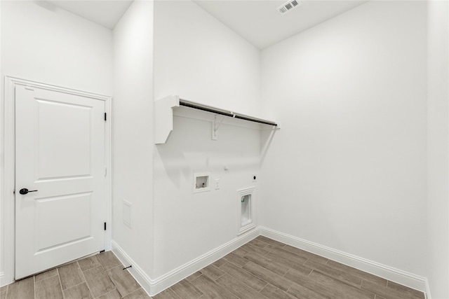 clothes washing area featuring hookup for a gas dryer, hookup for a washing machine, and electric dryer hookup