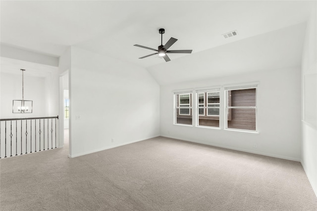 unfurnished room with lofted ceiling, a healthy amount of sunlight, and carpet floors