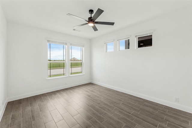 unfurnished room featuring dark wood-type flooring and ceiling fan