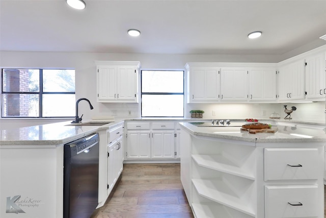 kitchen with white cabinetry, a center island, black dishwasher, and sink