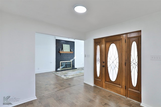 foyer featuring hardwood / wood-style flooring and a fireplace