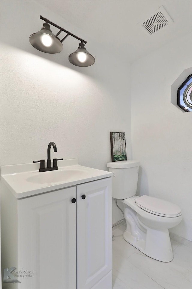 bathroom with vanity and toilet