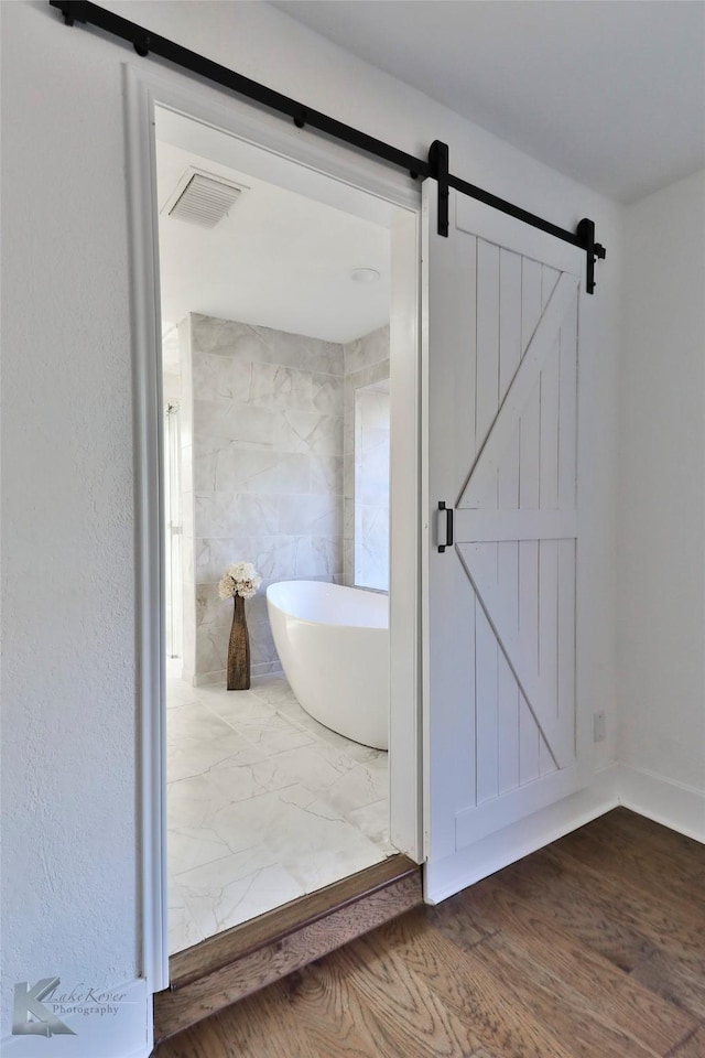 bathroom featuring a bathing tub and hardwood / wood-style floors