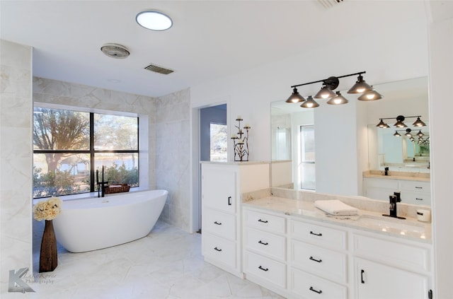 bathroom featuring vanity, tile walls, and a bathtub