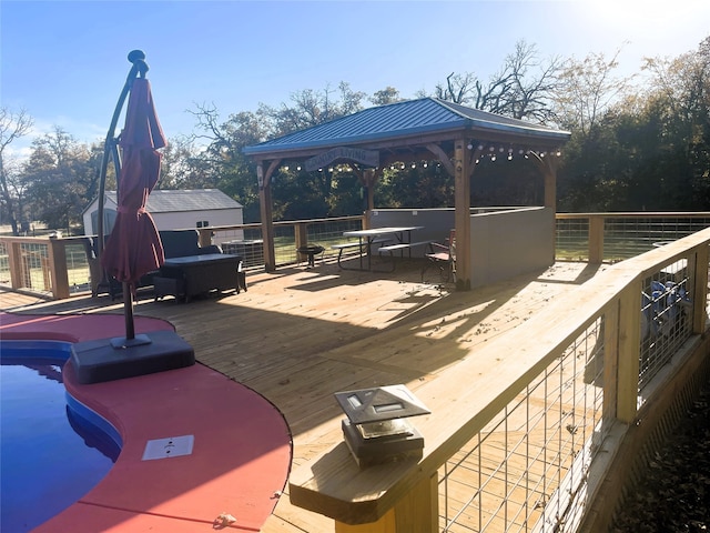 wooden deck with a pool and a gazebo