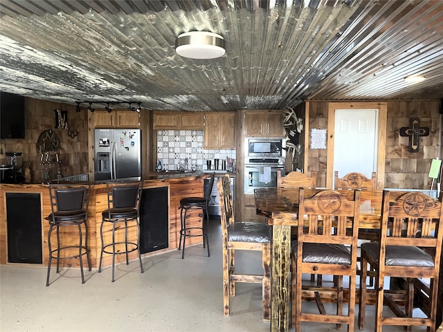 dining room featuring wooden walls