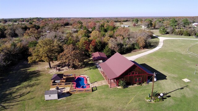 bird's eye view with a wooded view