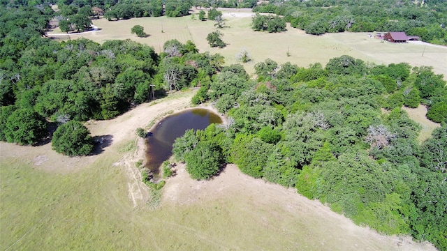 aerial view with a water view and a wooded view