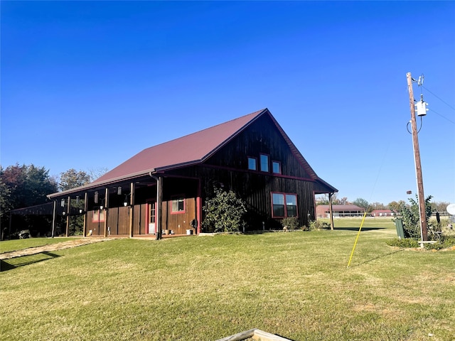 rear view of property with a lawn