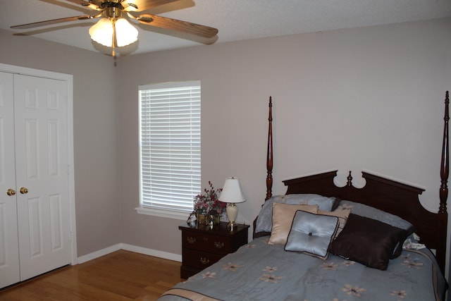 bedroom with ceiling fan, hardwood / wood-style flooring, and a closet