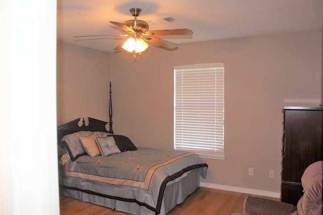 bedroom with hardwood / wood-style flooring and ceiling fan