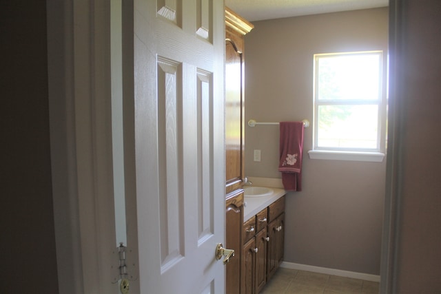 bathroom with tile patterned flooring and vanity