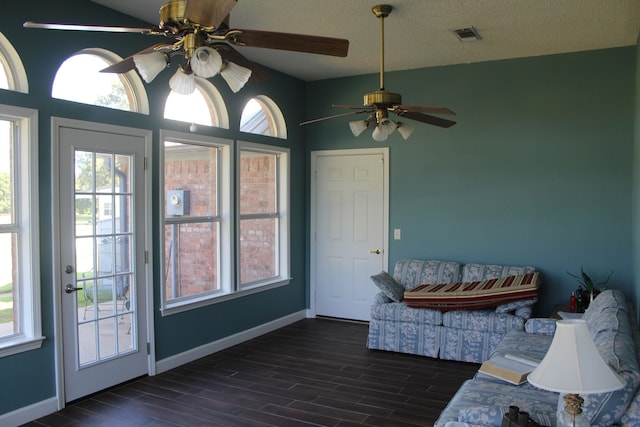 unfurnished sunroom featuring ceiling fan