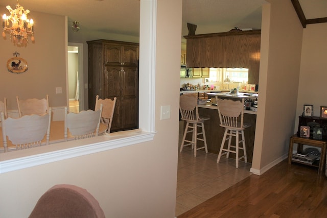 interior space with a notable chandelier and hardwood / wood-style flooring