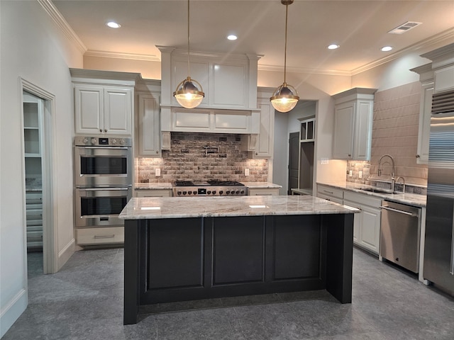 kitchen with pendant lighting, stainless steel appliances, light stone countertops, and a center island