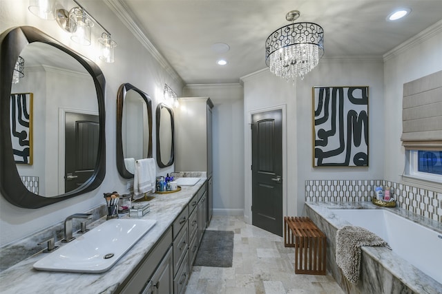 bathroom with vanity, a bathing tub, a chandelier, and ornamental molding