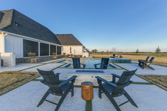 view of patio / terrace with a swimming pool and an outdoor fire pit