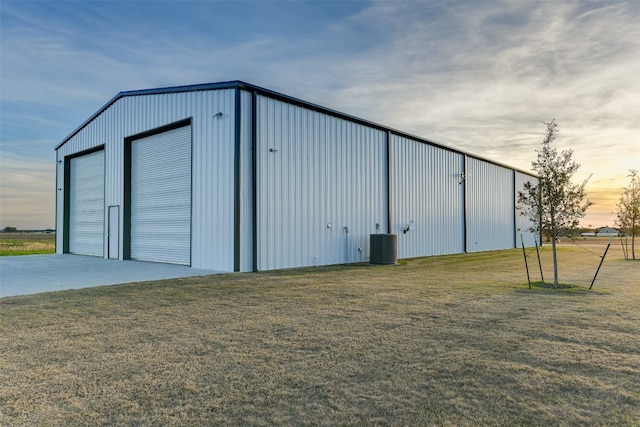 garage at dusk with a lawn