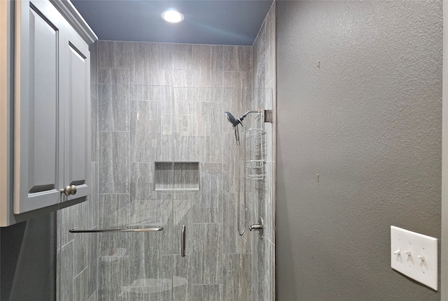 bathroom featuring a shower with door