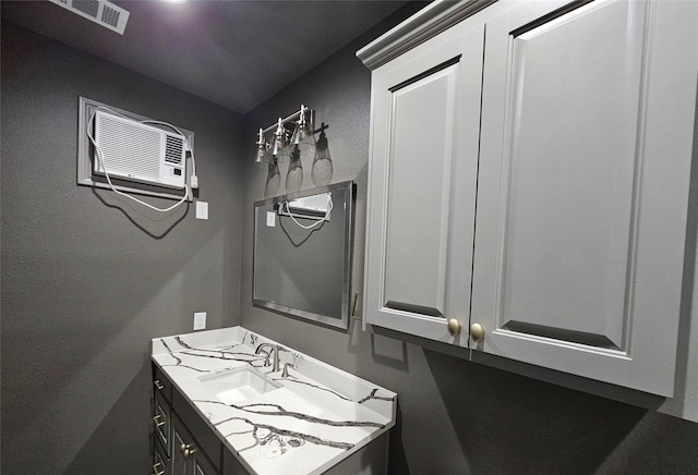 bathroom with vanity and a wall mounted air conditioner