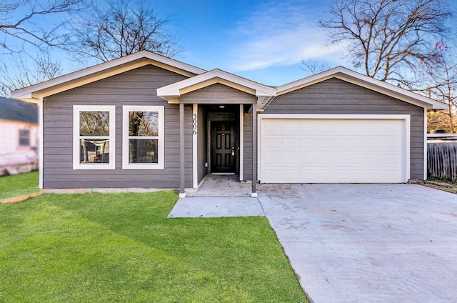 ranch-style home with a garage and a front lawn