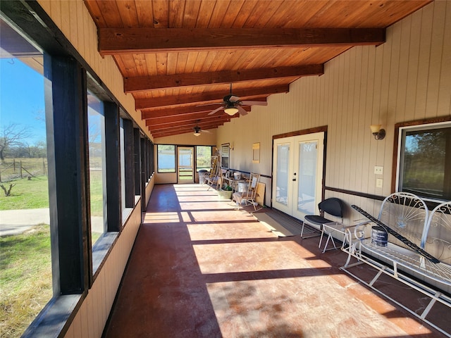 unfurnished sunroom featuring wooden ceiling, french doors, vaulted ceiling with beams, and ceiling fan