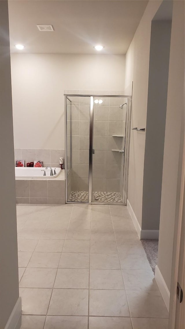 bathroom featuring tile patterned floors and plus walk in shower