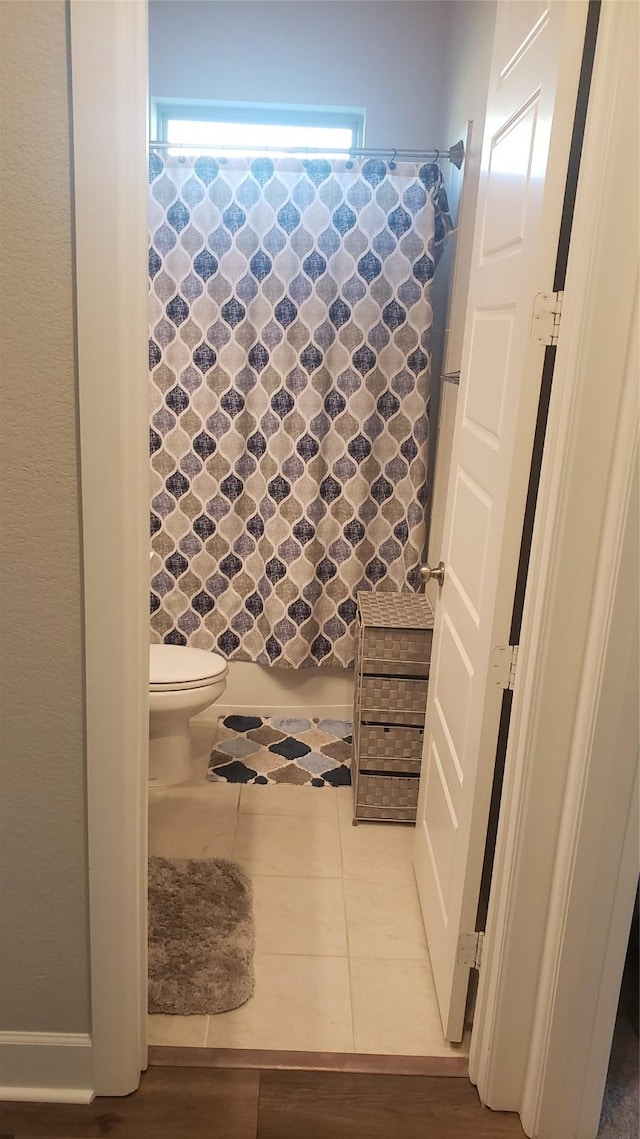 bathroom featuring toilet and tile patterned floors