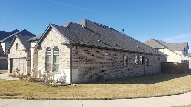 view of property exterior with a garage and a yard