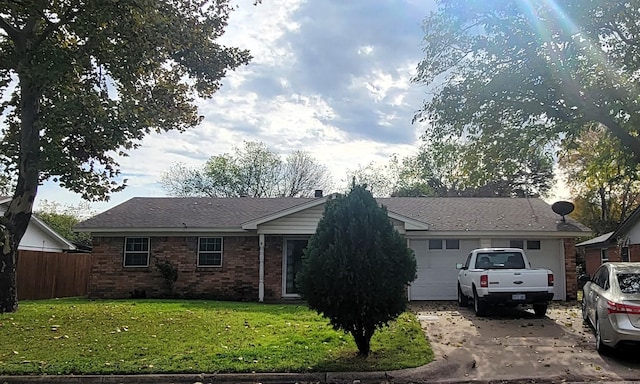 ranch-style home with a front yard and a garage