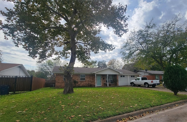 single story home with a garage and a front lawn