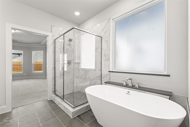 bathroom featuring shower with separate bathtub