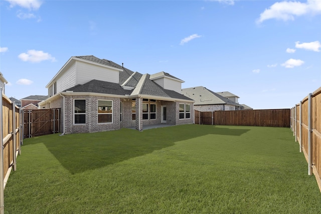 rear view of house featuring a lawn