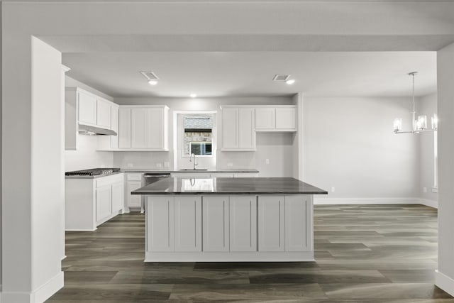 kitchen featuring white cabinetry, sink, dark hardwood / wood-style flooring, and a kitchen island