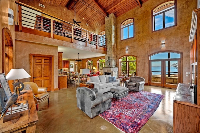 living room with beam ceiling, french doors, wood ceiling, ceiling fan, and high vaulted ceiling