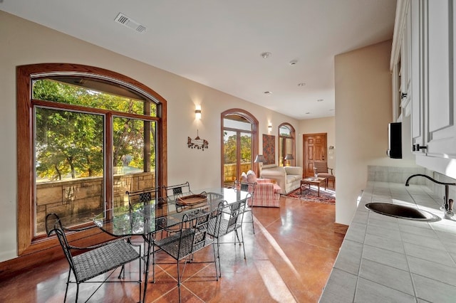 dining room with sink and light tile patterned floors