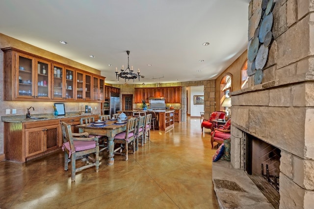 dining room with sink and an inviting chandelier