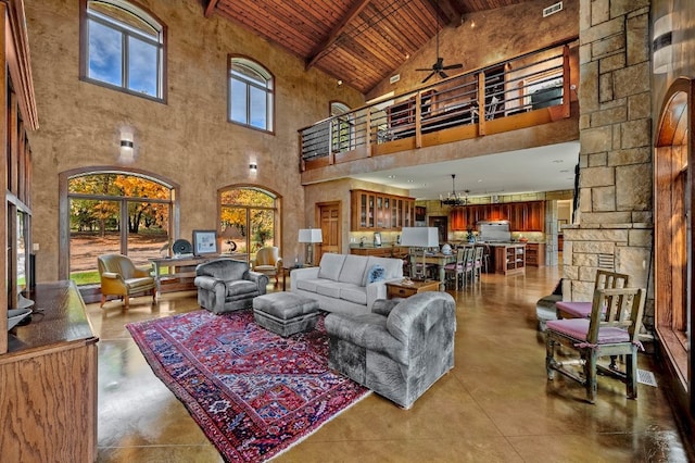 living room with ceiling fan, beamed ceiling, wood ceiling, and high vaulted ceiling