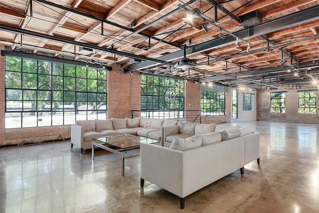 living room with brick wall and concrete floors