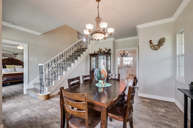 dining area featuring crown molding, dark hardwood / wood-style flooring, and a notable chandelier