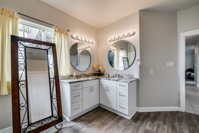 bathroom with vanity, a wealth of natural light, and hardwood / wood-style flooring