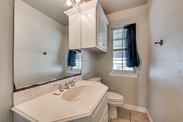 bathroom featuring tile patterned floors, vanity, and toilet