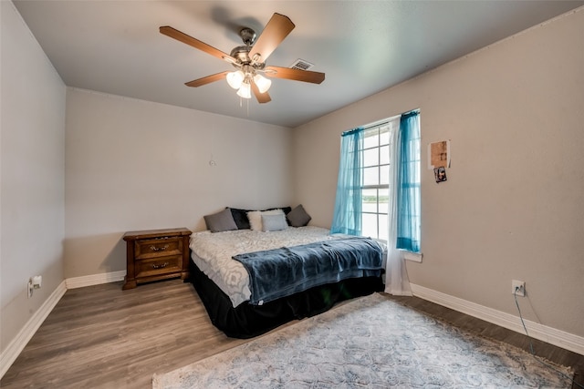 bedroom with ceiling fan and hardwood / wood-style flooring