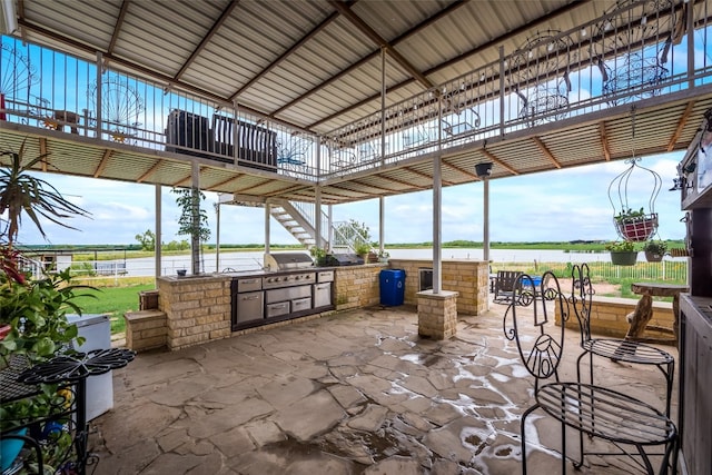 view of patio / terrace with grilling area and a water view