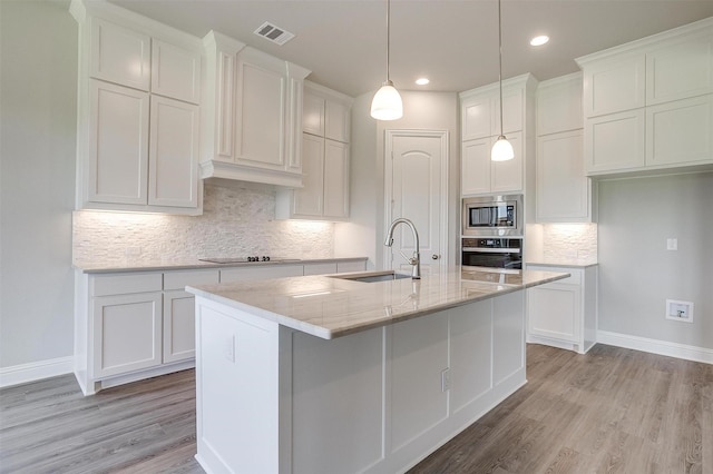 5621 Rutherford Dr, Midlothian, TX 76065 - kitchen featuring white cabinets, appliances with stainless steel finishes, a sink, baseboards, and visible vents
