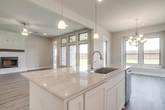 5621 Rutherford Dr, Midlothian, TX 76065 - kitchen featuring a sink, stainless steel dishwasher, light wood-type flooring, and white cabinetry