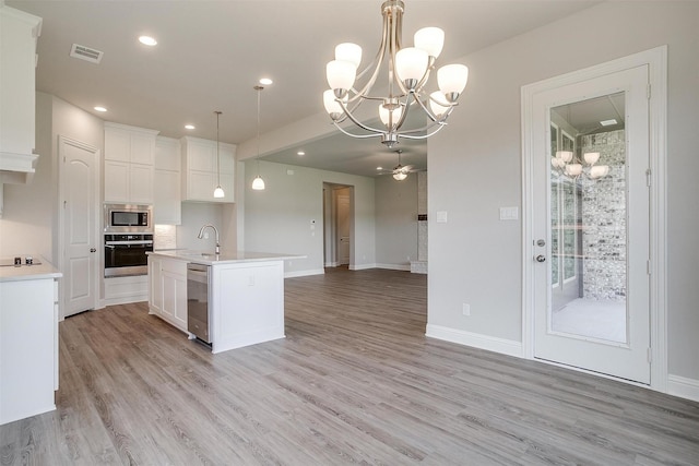5621 Rutherford Dr, Midlothian, TX 76065 - kitchen with visible vents, open floor plan, a chandelier, and stainless steel appliances