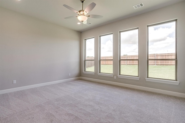 spare room with carpet and ceiling fan