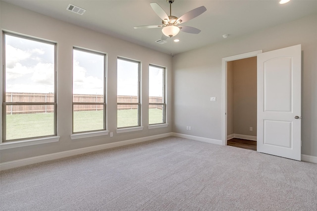 carpeted empty room featuring ceiling fan