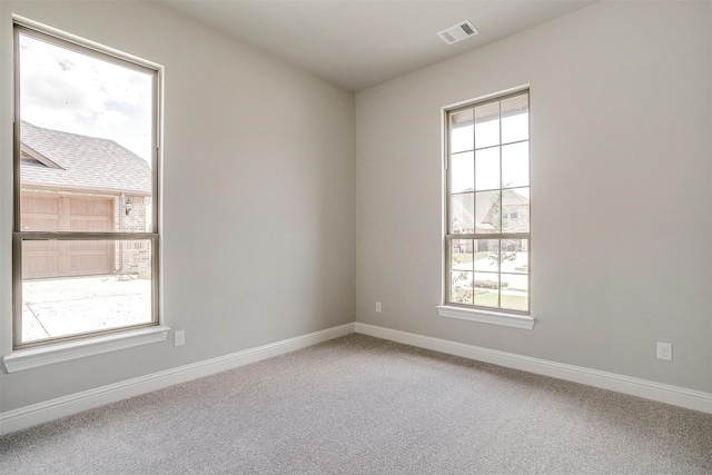 5621 Rutherford Dr, Midlothian, TX 76065 - carpeted spare room with baseboards, visible vents, and a healthy amount of sunlight